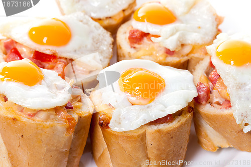Image of Baguette Slice with Ham and Fried Quail Egg