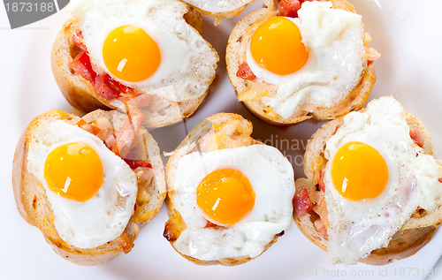 Image of Baguette Slice with Ham and Fried Quail Egg