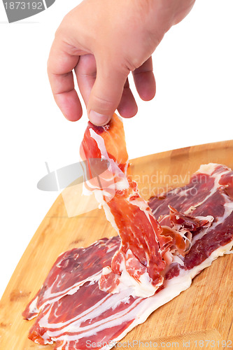 Image of Thinly Sliced ??Spanish Jamon with a Hand