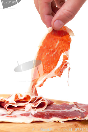 Image of Thinly Sliced ??Spanish Jamon with a Hand