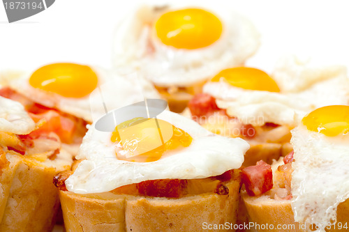 Image of Baguette Slice with Ham and Fried Quail Egg