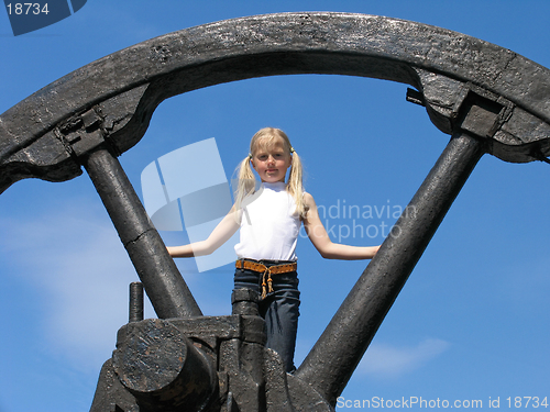 Image of Little girl and large wheel