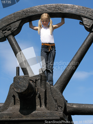 Image of Little girl and large wheel