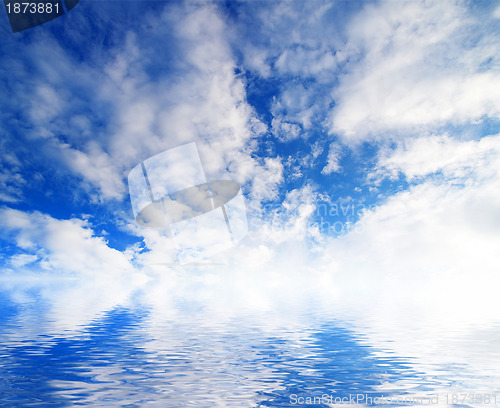 Image of white fluffy clouds with rainbow in the blue sky