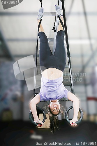 Image of carries out difficult exercise, sports gymnastics with a dark ba