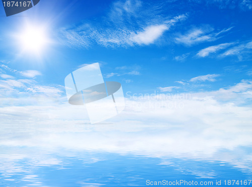 Image of white fluffy clouds with rainbow in the blue sky