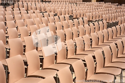 Image of rows of empty plastic seats