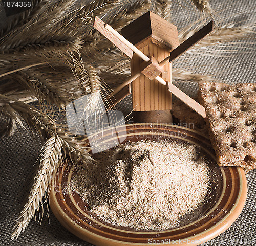 Image of Wholemeal flour and wheat on cloth sack, close-up