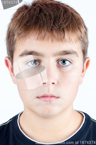 Image of studio portrait of young boy on white background