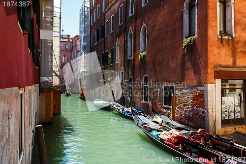 Image of Venice canal with boats and gondolier