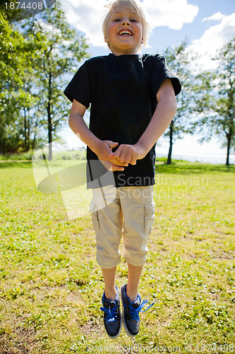 Image of Boy jumping outdoors
