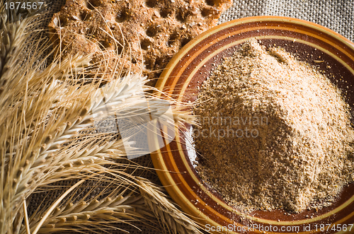 Image of Wholemeal flour and wheat on cloth sack, close-up