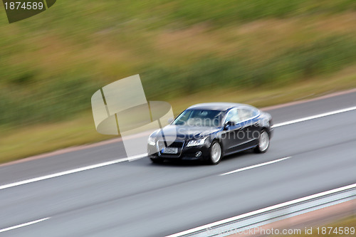 Image of Fast Black Car on Motorway