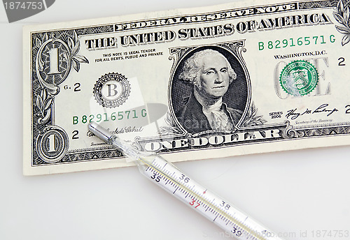 Image of One dollar banknote and thermometer