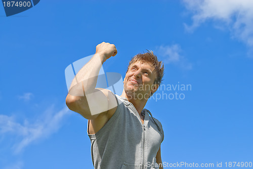 Image of Sporty man showing his strength