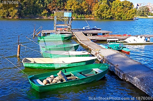 Image of Boats and other craft are tied near the old pier