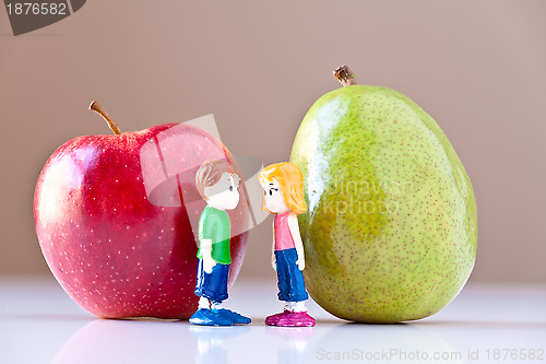 Image of Girl and Boy Discussing Healthy Nutrition (Pear and Apple)