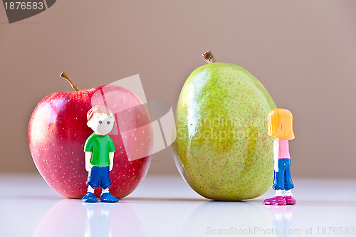 Image of Girl and Boy Arguing over Healthy Food Choices (Pear and Apple)