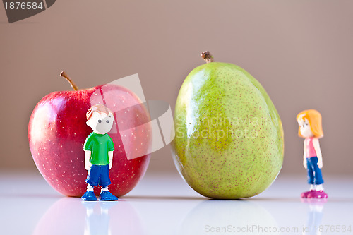 Image of Girl and Boy Overshelmed by Healthy Food Choices (Pear and Apple