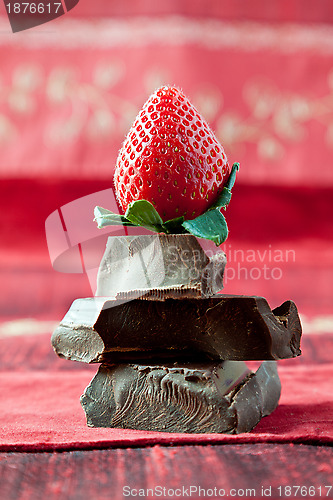 Image of Strawberry Balancing on a Pile of Dark Chocolate