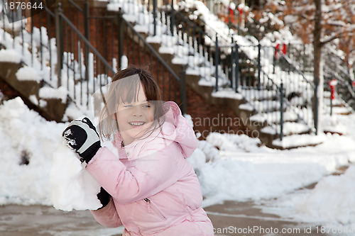 Image of Little Girl Throwing a Giant Snow Ball