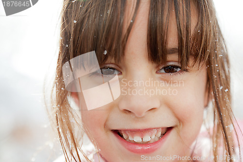 Image of Close Up of a Happy Little Girl with Snowflakes in Her Hair