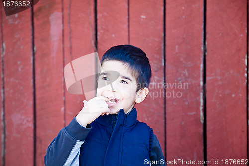 Image of Happy Little Boy with a Finger in his Mouth