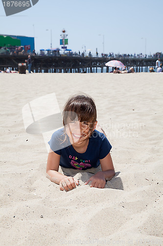 Image of Little Girl Lying on the Beach