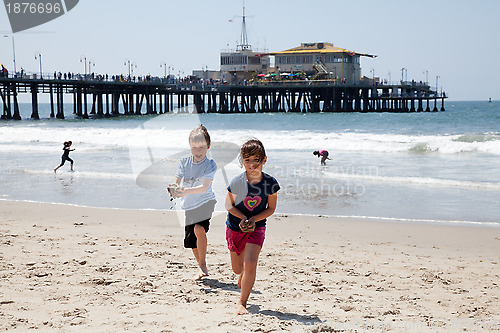 Image of Girl and Boy Playing on the Beach