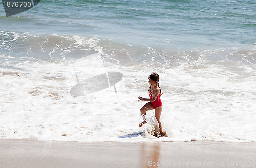 Image of Little Girl Running in the Surf on the Beach