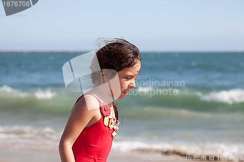 Image of Little Girl Walking and Talking by the Ocean