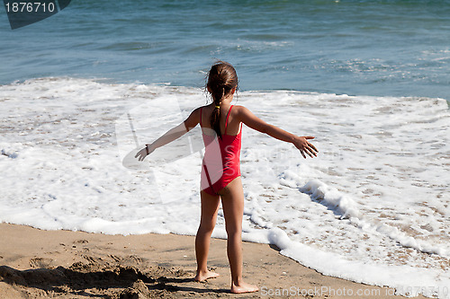 Image of Little Girl Waiting for the Ocean Wave 