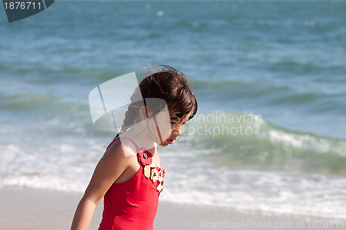 Image of Little Girl Relaxing by the Ocean