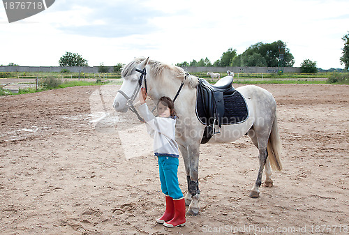 Image of Little girl ready for a horseback riding lesson