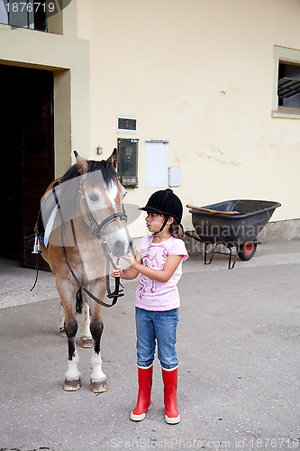 Image of Little girl ready for a horseback riding lesson