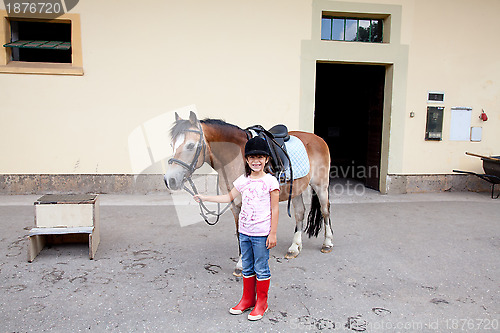 Image of Little girl ready for a horseback riding lesson