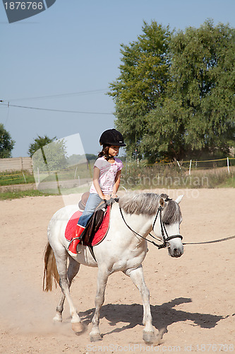 Image of Little Girl Taking Horseback Riding Lessons