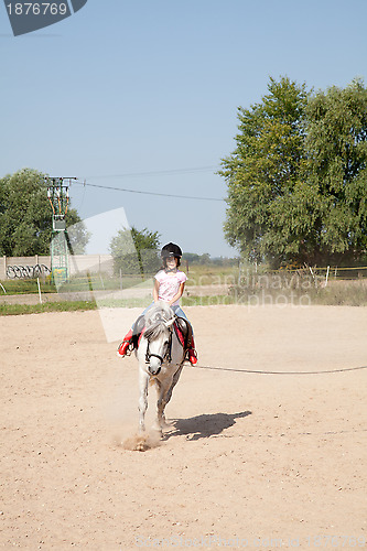 Image of Little Girl Taking Horseback Riding Lessons