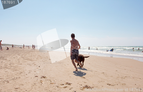 Image of Dog and boy running.