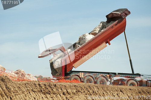 Image of Trailer of truck unloads stones