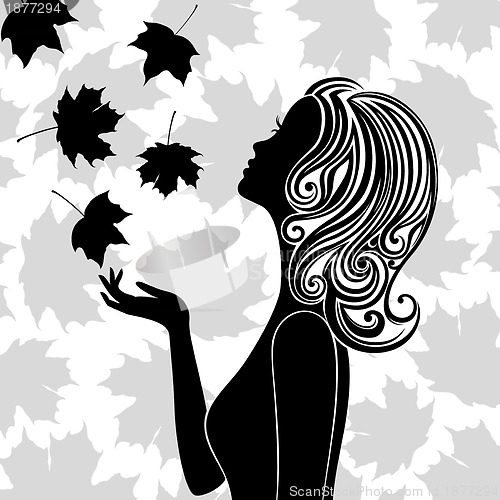 Image of Silhouette of young woman with flying leaves
