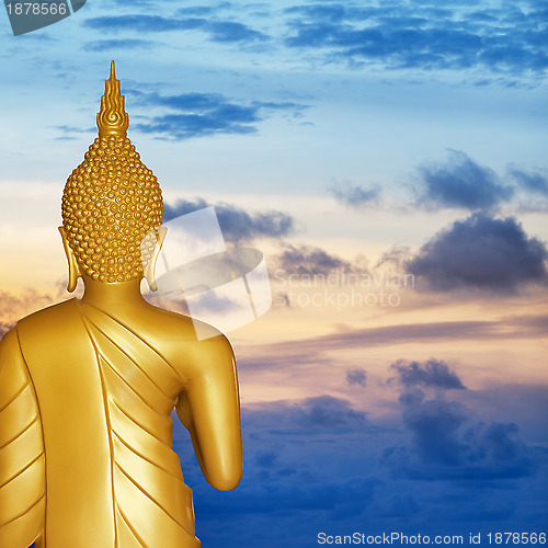 Image of Buddha statue at sunset. Rear view.