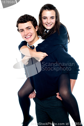 Image of Girl riding piggyback and embracing boy tightly