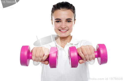 Image of Image of young girl posing with dumbbells