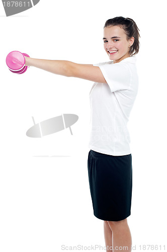 Image of Happy fitness girl lifting dumbbells