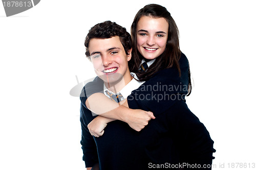 Image of Young girl on her friends back, enjoying piggy ride