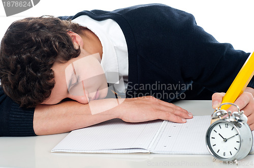 Image of Teenager dozing off while writing his test