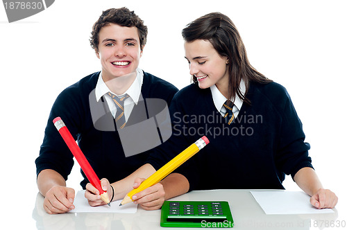 Image of Girl making corrections on her partners examination paper