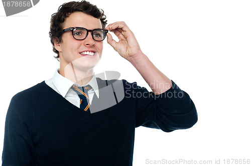 Image of Smiling student adjusting his spectacles