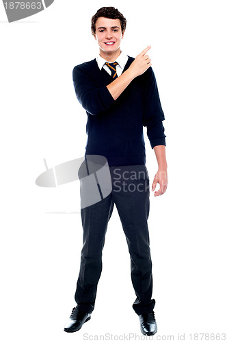 Image of Full length portrait of teenager pointing away